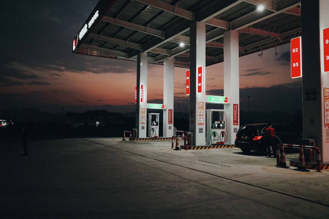 a-gas-station-at-night-with-a-car-parked-at-the-gas-pump-arzbqwzcai4